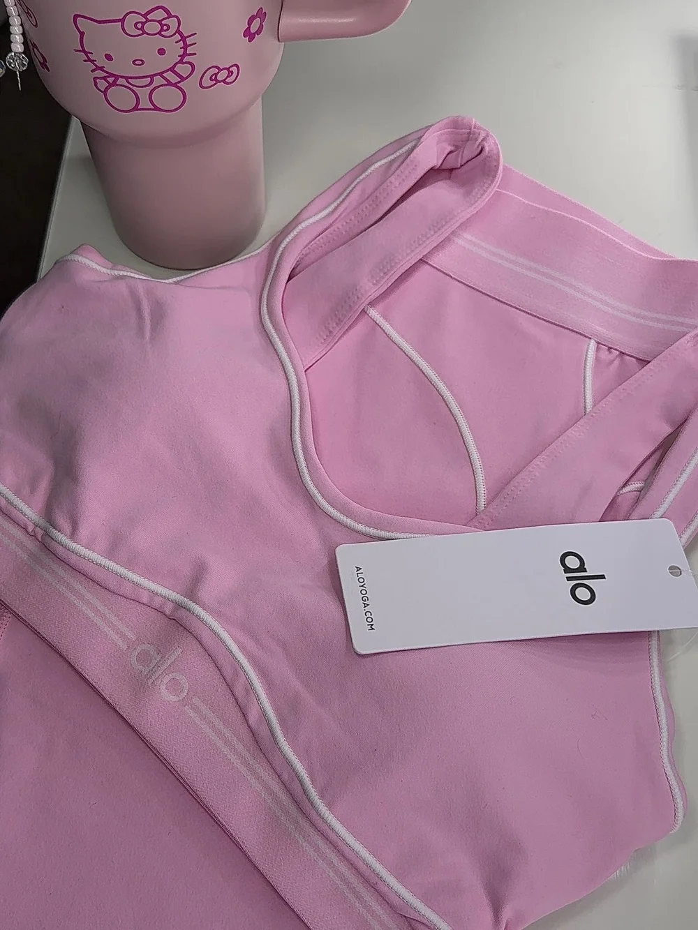 ALO Yoga Light Pink Racerback Sports Bra with White Piping
